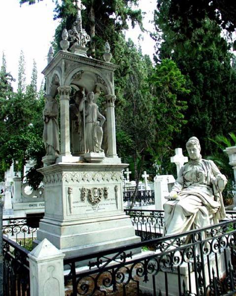 Tomb of Dimos Georgoulas & Maria Kassimati. Funerary monument in the ciborium type with sculpted figures and a seated statue of a woman. Sculptor: Dimitrios Filippotis (1839-1919)