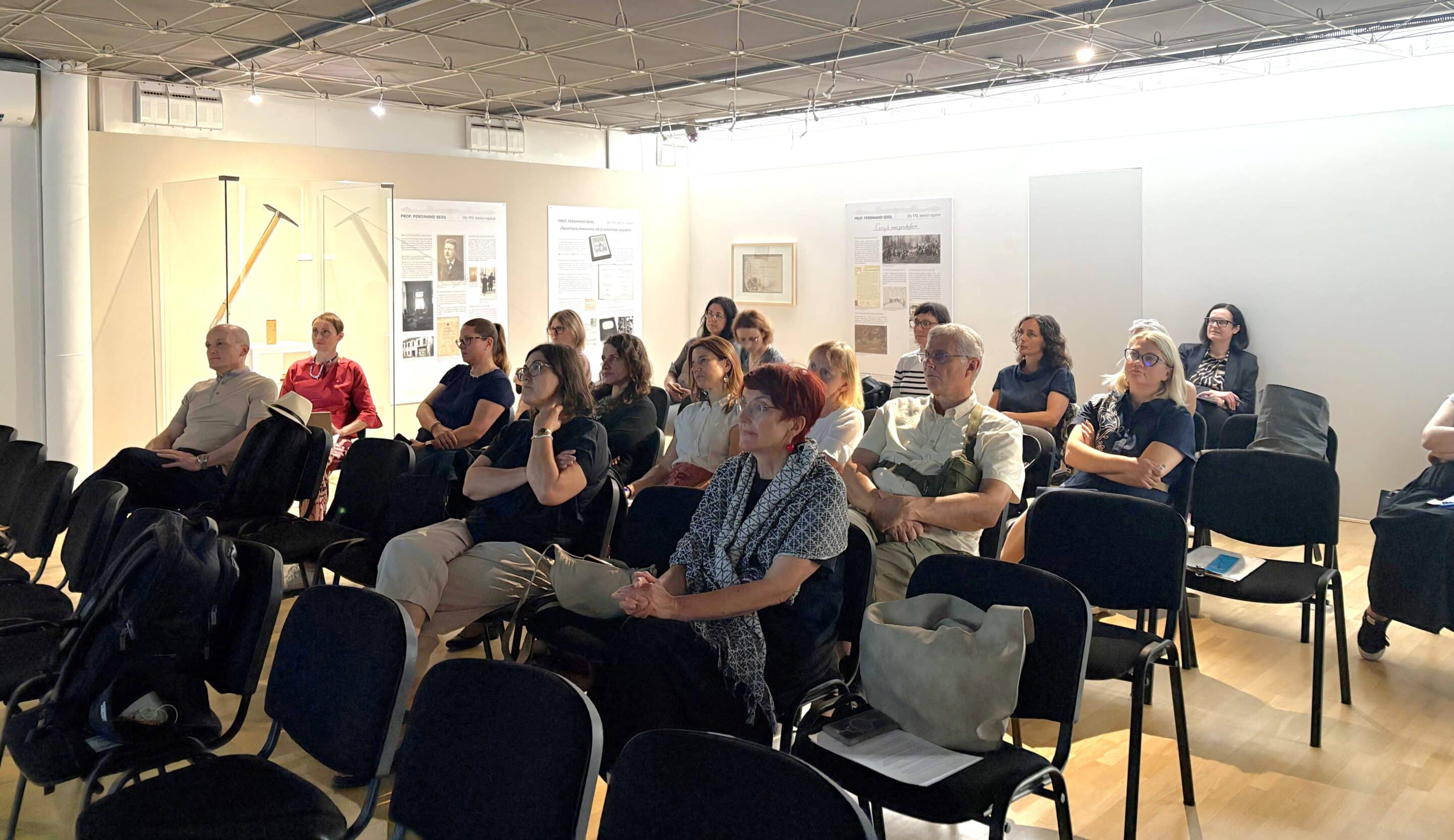 Participants of the Slovenian cultural routes meeting in Novo mesto seated in a bright room